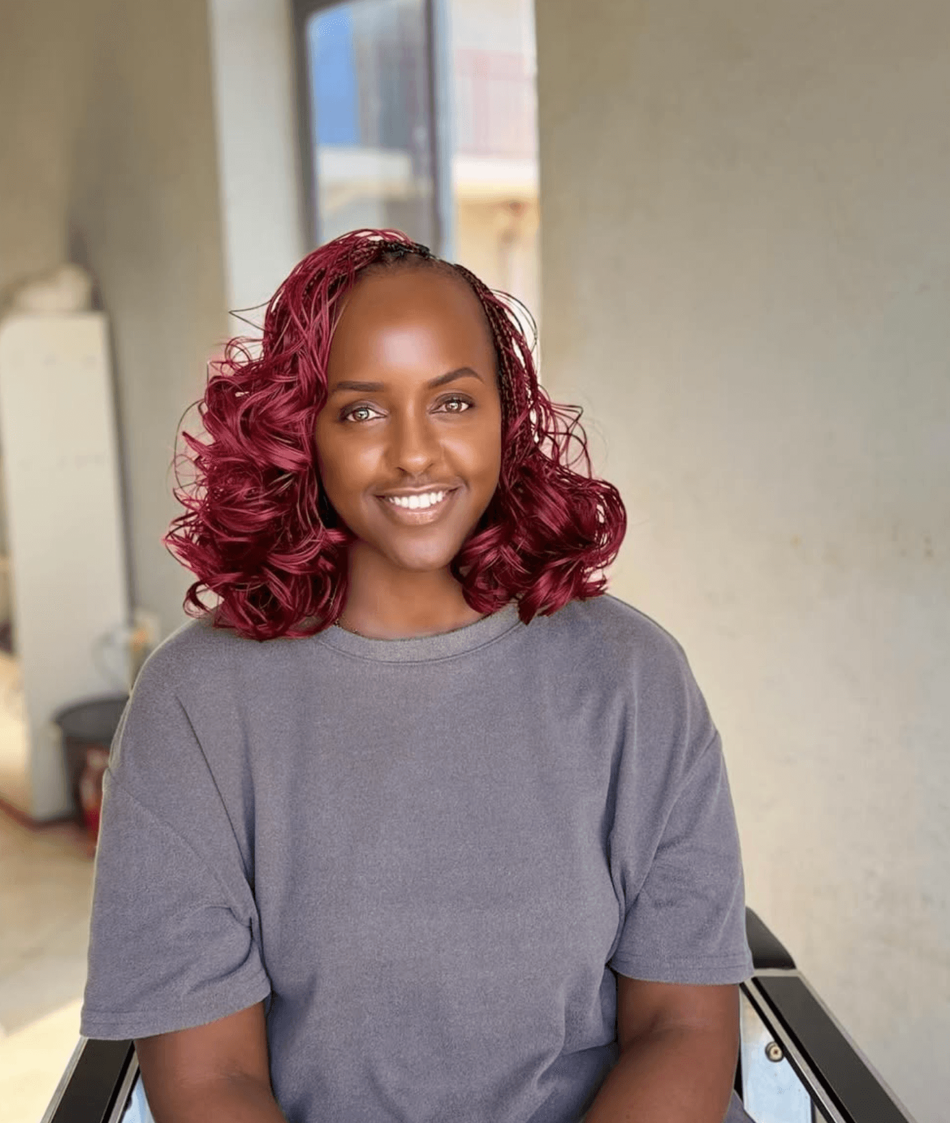 Editorial portrait of a Kigali Braids client